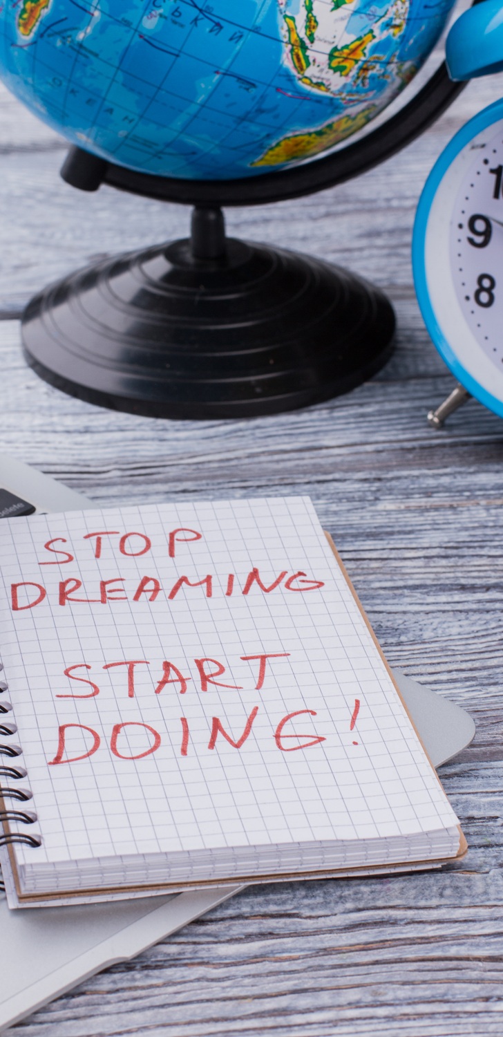 Stop dreaming start doing. Motivation slogan with laptop poc and